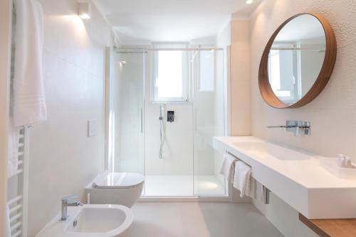 a bathroom with a shower and a toilet and a sink at Hotel Mistral in Termoli