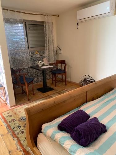 a bedroom with a bed with two pillows on it at פינה קסומה בהר in Lotem