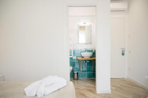 a white bathroom with a sink and a mirror at B&B DieMme Amalfi Coast in Vietri sul Mare