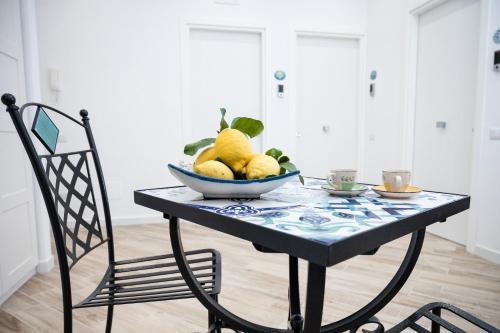 a bowl of fruit on a table with a chair at B&B DieMme Amalfi Coast in Vietri sul Mare