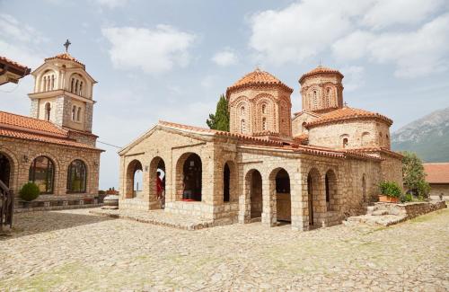 an old stone church with two towers on top at Edelweiss Villa Trpejca in Ohrid