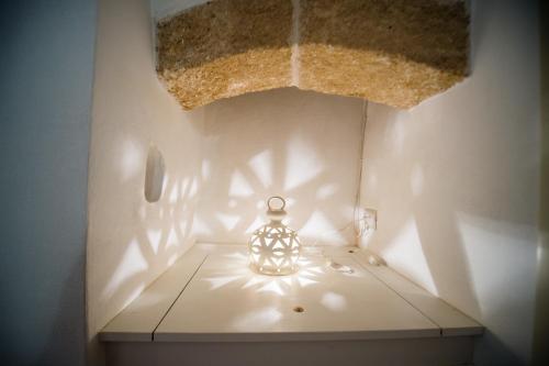 a glass vase sitting on a table in a room at B&B Casa Dorsi in Polignano a Mare