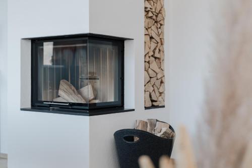 a person reaching for a book in a fireplace at Seehaus Zeppelin in Zell am See