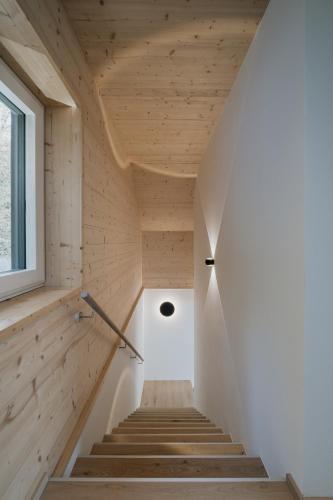 a staircase in a house with wooden walls and a window at Seehaus Zeppelin in Zell am See