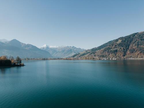 a large body of water with mountains in the background at Seehaus Zeppelin in Zell am See