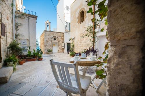 an outdoor patio with a table and a chair at B&B Casa Dorsi in Polignano a Mare