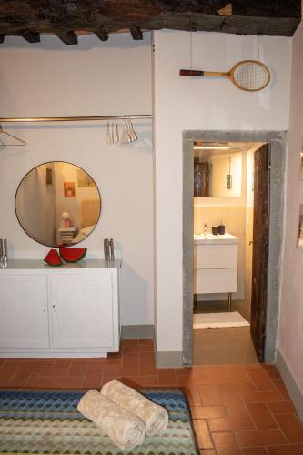 a bathroom with a mirror and a sink at Bonaventura in Greve in Chianti