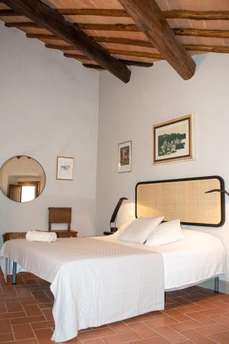 a bedroom with two beds and a mirror at Bonaventura in Greve in Chianti