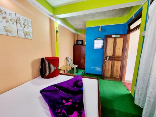 a room with a bed and a room with a door at Lava swagat homestay in Lava