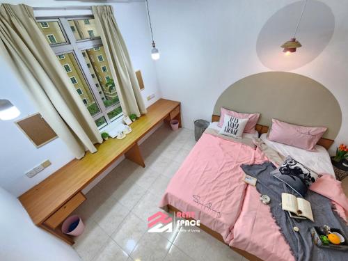 a small bedroom with a pink bed and a window at Ixora Coliving Lifestyle Homestay in Ayer Keroh