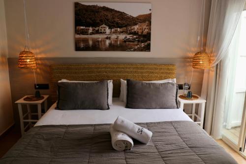 a bedroom with a large bed with towels on it at Hotel Sa Tuna in Begur