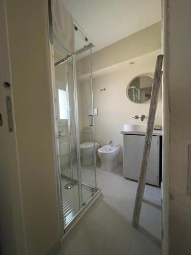 a bathroom with a glass shower and a toilet at Domus de Diana in Olbia