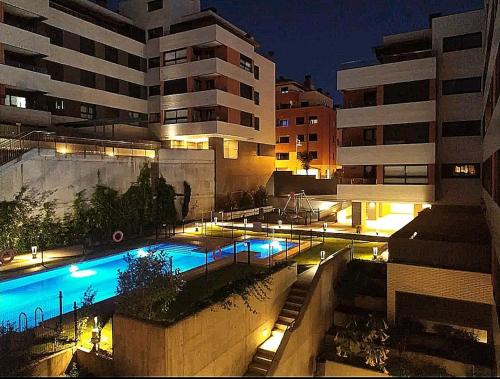 a large building with a swimming pool at night at COSTA NORTE Apartamento con Terraza Garaje y Piscina in Castro-Urdiales