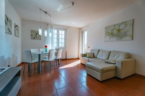 a living room with a couch and a table at Mary Rose Apartments in Oliveto Lario