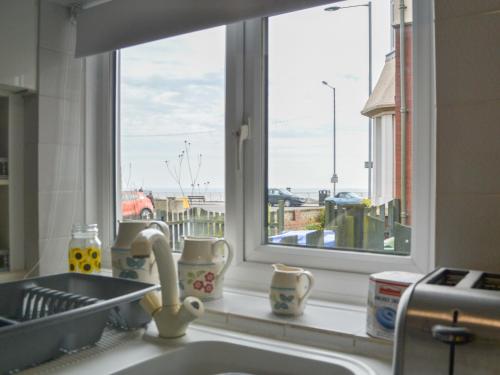 a kitchen sink with a window in a kitchen at The Cottage in Bridlington