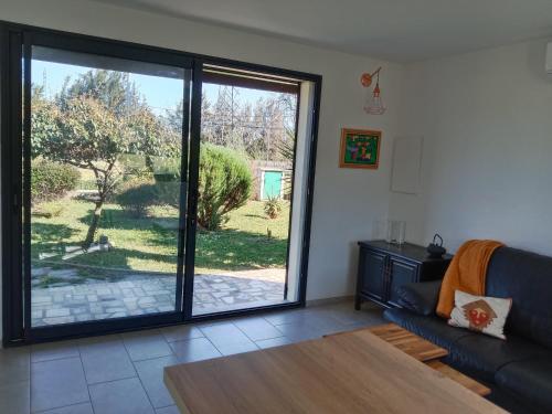 a living room with a large sliding glass door at SANTA-LUCIA in Santa-Lucia-di-Moriani