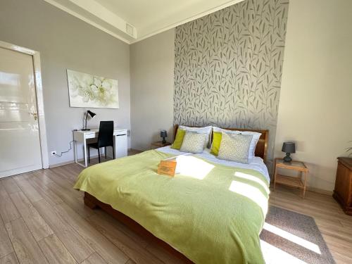 a bedroom with a bed and a desk in it at ORANGEHOMES One Bedroom Cozy Apartment in Budapest