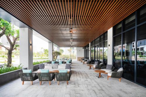a lobby of a building with chairs and tables at Anya Hotel Quy Nhon in Quy Nhon