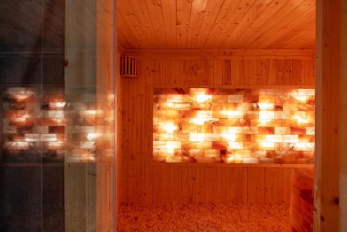 a room with a fireplace in a wooden wall at Anya Hotel Quy Nhon in Quy Nhon