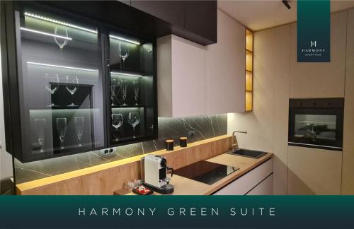 a kitchen with a sink and a window with wine glasses at Harmony Apartmani Arandjelovac in Arandjelovac