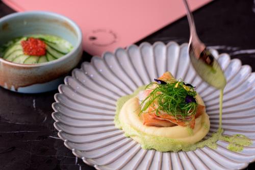 a plate of food on a table with a fork at Hotel Saski Krakow Curio Collection by Hilton in Kraków
