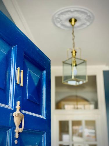 a blue door with a chandelier in a room at Superbly Located Handsome Georgian Townhouse - Pass the Keys in Shrewsbury