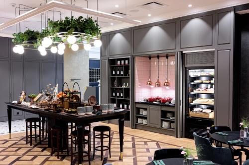 a kitchen with a table and some chairs at Hotel Saski Krakow Curio Collection by Hilton in Kraków
