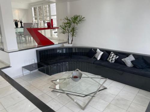 a living room with a couch and a glass table at Casa com vista pro Cristo Redentor in Niterói