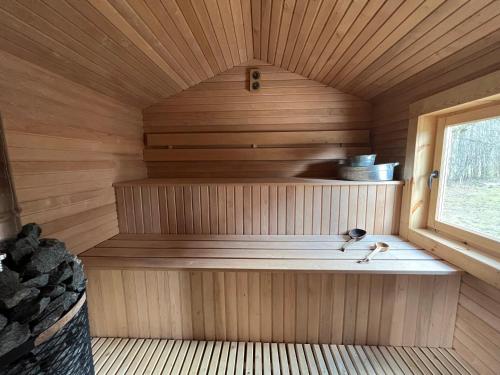 an inside of a sauna with a window at Villa Arjola in Kaltanėnai