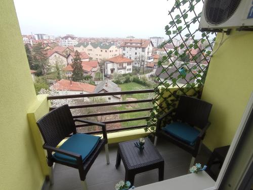 two chairs and a table on a balcony with a view at STAN NA DAN BIJELJINA in Bijeljina