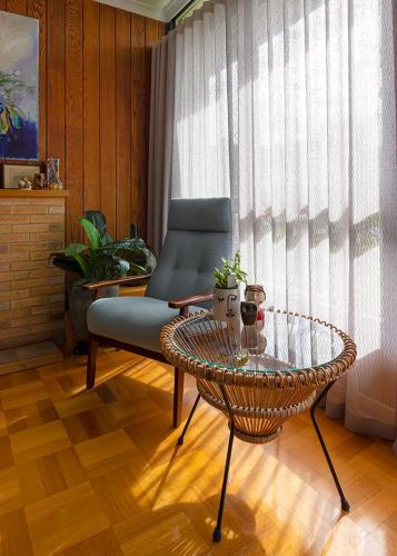 a living room with a table and a chair at Jamaica Mid-Century in Seaton