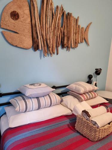 a room with pillows and a wall with a rack of antlers at VILLA VILLACOLLE in Procchio