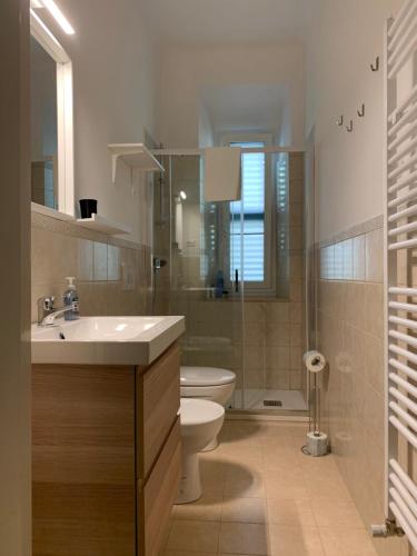 a bathroom with a sink and a toilet and a shower at Clara Luna appartamento turistico in Osimo