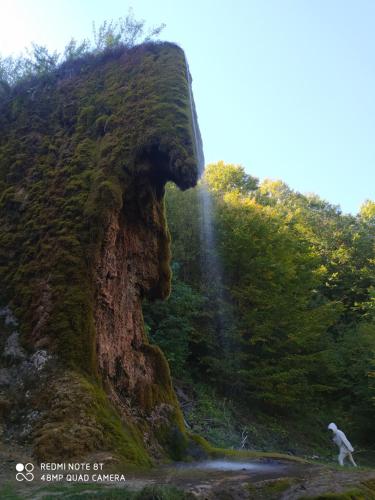 a person riding a bike in front of a waterfall at Vodenica Lug in Strmosten