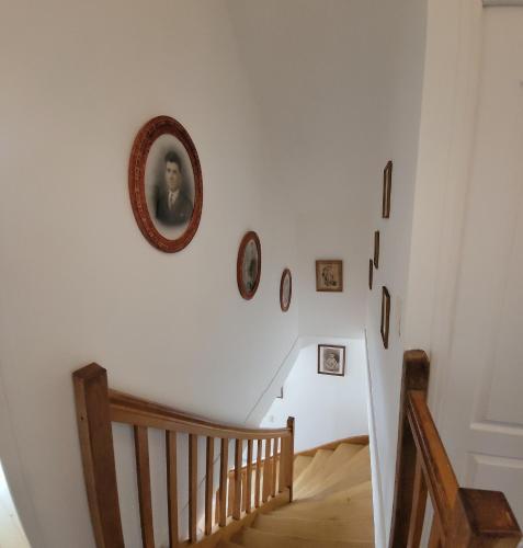 a stairway with a picture of a woman on the wall at Les hauts Brianço in Solignac