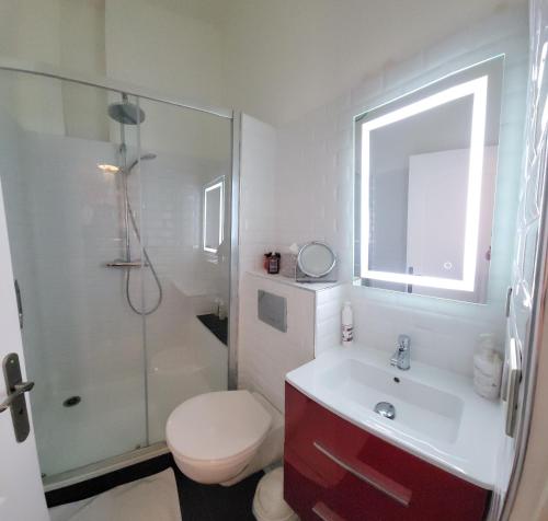a bathroom with a toilet and a sink and a shower at Les hauts Brianço in Solignac