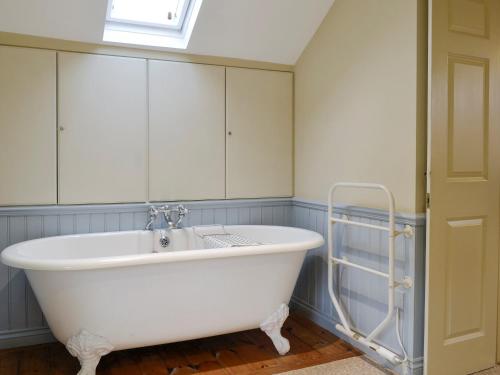 a white bath tub in a bathroom with a window at Brasscam in Rosthwaite