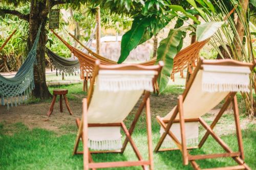 a group of chairs in a hammock under a tree at Ocacocar - Milagres in São Miguel dos Milagres