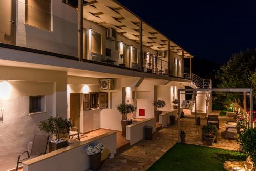 a building with a courtyard at night at Lighthouse Apartments in Stoupa