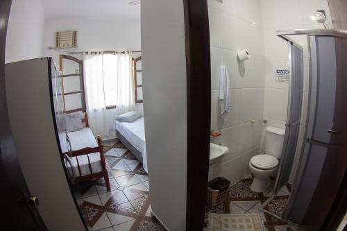 a small bathroom with a toilet and a sink at Pousada Pérola do Guarujá Ltda- Me in Guarujá