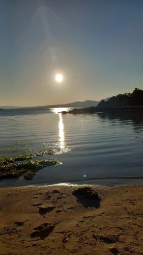 a sun setting over a body of water at Domus de Diana in Olbia