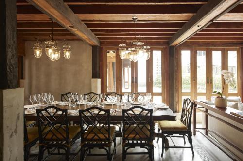 a dining room with a long table and chairs at Aleenta Retreat Chiang Mai - The Leading Hotels of the World in Chiang Mai