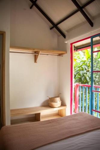 a bedroom with a bed next to a window at Apartamento amplio cerca al parque Guatape - Pajaros in Guatapé