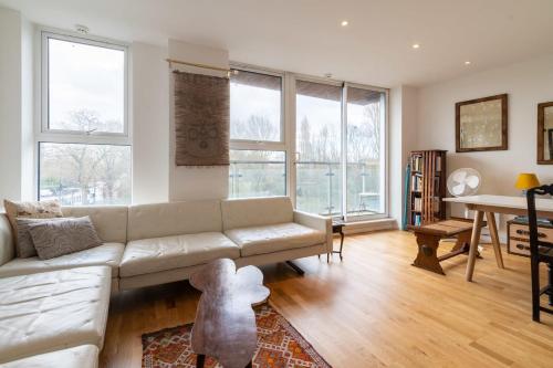 a living room with a couch and a table at Regent's Canal View Apartment in London