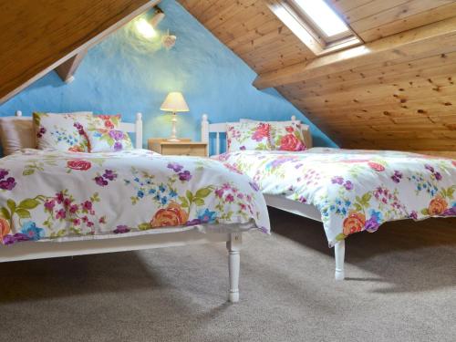 a bedroom with two beds in a attic at Minallt in Nefyn
