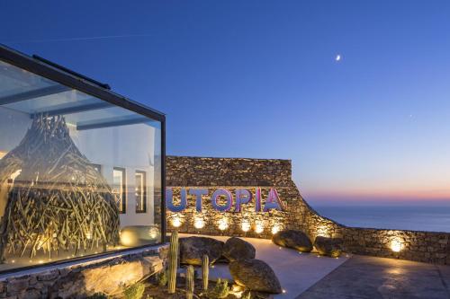 a store window with a sign that reads hope at Myconian Utopia Relais & Chateaux in Elia Beach