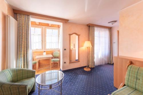 a living room with a couch and a table at Hotel Relais Orsingher in Fiera di Primiero