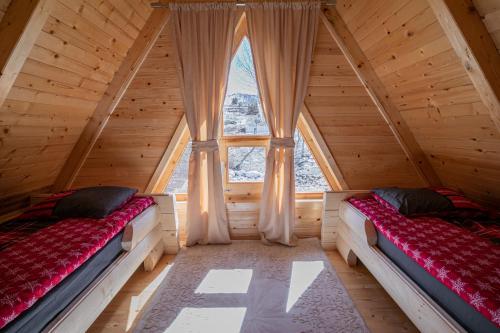 a room with two beds in a log cabin at Nicola’s hill in Žabljak