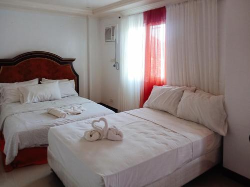 Voodi või voodid majutusasutuse RedDoorz at Caree Boutique Hotel Bulan Sorsogon toas