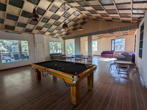 a large room with a pool table in it at The 9 Oaks by BOP group of Stay and Cafe in Mussoorie